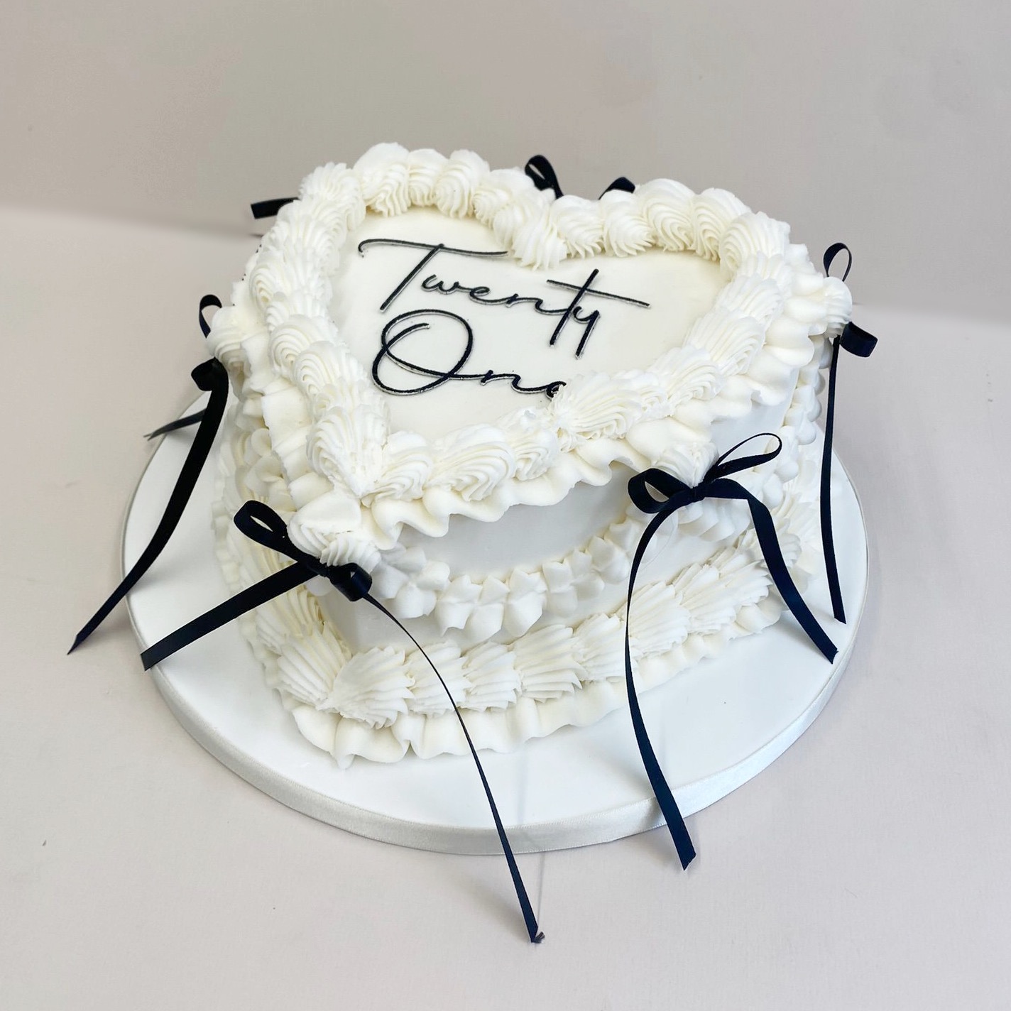 White Lambeth Cake with black bows.